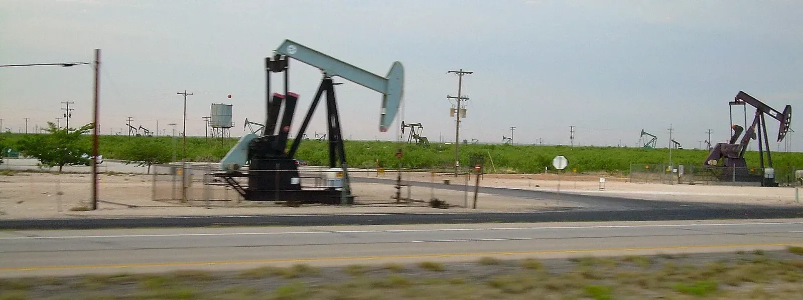 Field of oil pumpjacks along Interstate 20 near Midland, Texas