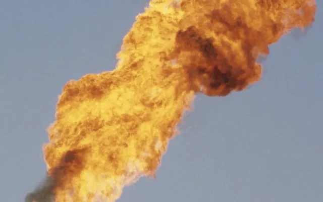 Flare burning gas during a flow test on an onshore oil well